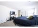 Spacious main bedroom with a large window and dark grey tv stand at 2678 Weathered Copper Ave, North Las Vegas, NV 89086