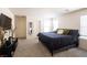 Spacious main bedroom with two windows, an ensuite bathroom, and neutral decor at 2678 Weathered Copper Ave, North Las Vegas, NV 89086