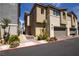 Well-maintained townhome showcasing desert landscaping, a two-car garage, and a welcoming exterior facade at 2678 Weathered Copper Ave, North Las Vegas, NV 89086