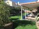 Inviting backyard with green synthetic lawn, covered patio, and attractive landscaping for outdoor living at 2747 Sandalwood Ave, Henderson, NV 89074
