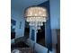 A close up of a beautiful chandelier in the dining room creating an elegant and inviting atmosphere at 2747 Sandalwood Ave, Henderson, NV 89074