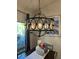 Chandelier hangs over dining room table in a naturally lit room at 2747 Sandalwood Ave, Henderson, NV 89074