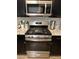 Stainless steel oven and stovetop beneath a stainless steel microwave at 2747 Sandalwood Ave, Henderson, NV 89074