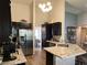 Spacious kitchen featuring stainless steel appliances, granite countertops and barstool seating at the counter at 2747 Sandalwood Ave, Henderson, NV 89074