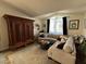 Cozy living room with a large sofa and antique cabinet creating a comfortable and stylish space at 2747 Sandalwood Ave, Henderson, NV 89074