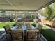 Relaxing patio with a dining table and lush greenery providing a serene outdoor dining experience at 2747 Sandalwood Ave, Henderson, NV 89074