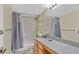 Bathroom with gray shower curtain, granite countertop, and a mirror at 2831 Geary Pl # 2918, Las Vegas, NV 89109