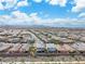 An aerial view of a community with mountain backdrop under a bright blue sky with desert landscape at 2832 Aragon Terrace Way, Henderson, NV 89044