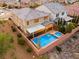 This aerial shot showcases a backyard pool and lounge area for luxurious relaxation at 2832 Aragon Terrace Way, Henderson, NV 89044