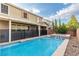 Spacious backyard with a sparkling pool, spa, and lush desert landscaping at 2832 Aragon Terrace Way, Henderson, NV 89044