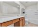 Well-lit bathroom features a vanity with wood cabinets, solid surface countertop, tub-shower, and ample storage at 2832 Aragon Terrace Way, Henderson, NV 89044