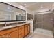 Bathroom featuring a dual sink vanity, granite countertops and a glass enclosed shower at 2832 Aragon Terrace Way, Henderson, NV 89044