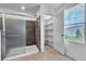 Bathroom featuring glass shower with modern tile work and built-in shelving at 2832 Aragon Terrace Way, Henderson, NV 89044