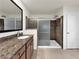Bathroom featuring a granite countertop, single sink, and a glass enclosed shower at 2832 Aragon Terrace Way, Henderson, NV 89044
