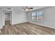 Bright bedroom with laminate floors and view of tile roofs at 2832 Aragon Terrace Way, Henderson, NV 89044