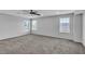 A spacious bonus room features neutral walls and carpet along with bright windows at 2832 Aragon Terrace Way, Henderson, NV 89044