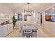 Bright dining room with tile floors and modern chandelier at 2832 Aragon Terrace Way, Henderson, NV 89044