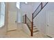 Well-lit foyer featuring staircase, white door, and tile flooring at 2832 Aragon Terrace Way, Henderson, NV 89044