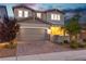 This front exterior offers a two-story facade, garage, and cozy front porch with inviting curb appeal at 2832 Aragon Terrace Way, Henderson, NV 89044
