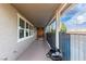 Covered front porch with modern black grill and stylish wood accent wall at 2832 Aragon Terrace Way, Henderson, NV 89044