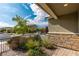 Charming front yard with desert landscaping, stone accents, and a wrought iron gate on a sunny day at 2832 Aragon Terrace Way, Henderson, NV 89044