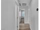 Bright hallway with durable wood flooring and neutral paint creates a seamless flow between rooms at 2832 Aragon Terrace Way, Henderson, NV 89044