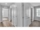 Bright hallway with multiple doorways and durable wood flooring providing access to various rooms at 2832 Aragon Terrace Way, Henderson, NV 89044