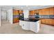 Bright kitchen with black granite countertops, island and stainless steel appliances at 2832 Aragon Terrace Way, Henderson, NV 89044