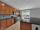 Kitchen boasts granite countertops, stainless steel appliances, an island sink, and backyard access for easy outdoor dining at 2832 Aragon Terrace Way, Henderson, NV 89044