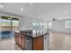 Open concept kitchen with island, stainless steel appliances and sliding glass doors at 2832 Aragon Terrace Way, Henderson, NV 89044