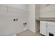 Functional laundry room with tiled floor, white cabinets, and wire shelving for organized storage at 2832 Aragon Terrace Way, Henderson, NV 89044