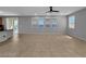 Bright and open living room with seamless flow to kitchen, featuring neutral walls and abundant natural light from large windows at 2832 Aragon Terrace Way, Henderson, NV 89044