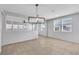 Bright living room with tile flooring, neutral walls, modern lighting and bright windows at 2832 Aragon Terrace Way, Henderson, NV 89044