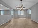 Spacious living room with tile flooring, a modern chandelier, and bright windows at 2832 Aragon Terrace Way, Henderson, NV 89044