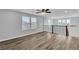 Spacious loft area featuring wood-style flooring, a contemporary ceiling fan, and plentiful natural light from large windows at 2832 Aragon Terrace Way, Henderson, NV 89044
