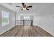 Bright and airy loft featuring modern ceiling fan, wood flooring and decorative railing overlooking the downstairs at 2832 Aragon Terrace Way, Henderson, NV 89044