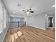Open loft area featuring sleek railings, modern ceiling fan, and beautiful wood-look floors at 2832 Aragon Terrace Way, Henderson, NV 89044