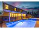 Inviting backyard pool and hot tub with an iron fence and exterior view of the home at dusk at 2832 Aragon Terrace Way, Henderson, NV 89044