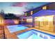 Inviting backyard pool and hot tub with an iron fence and exterior view of the home at dusk at 2832 Aragon Terrace Way, Henderson, NV 89044