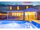 Inviting backyard pool and hot tub with an iron fence and exterior view of the home at dusk at 2832 Aragon Terrace Way, Henderson, NV 89044