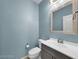 Stylish powder room with blue walls, vanity, and a toilet at 2832 Aragon Terrace Way, Henderson, NV 89044