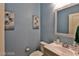 Powder room featuring blue walls, modern sink, and decorative artwork at 2832 Aragon Terrace Way, Henderson, NV 89044