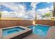 Sparkling pool and spa in backyard surrounded by brick wall and desert landscape at 2832 Aragon Terrace Way, Henderson, NV 89044