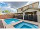 Private backyard featuring a pool, spa, covered patio, and lush desert landscaping at 2832 Aragon Terrace Way, Henderson, NV 89044