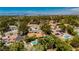 Overview of a residential area with mature trees, pools, and solar panels on the rooftops at 3007 La Mesa Dr, Henderson, NV 89014