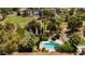 Aerial view showcasing a backyard pool oasis with mature landscaping, lush greenery, and a golf course nearby at 3007 La Mesa Dr, Henderson, NV 89014