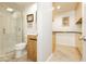 Bathroom featuring a glass enclosed shower, wood vanity and travertine flooring at 3007 La Mesa Dr, Henderson, NV 89014