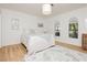 Cozy bedroom with neutral tones, a comfortable bed, and natural light streaming through charming arched windows at 3007 La Mesa Dr, Henderson, NV 89014