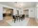Bright dining room with modern lighting, seamlessly connecting to the kitchen with stainless steel appliances at 3007 La Mesa Dr, Henderson, NV 89014