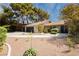 Inviting single-story home with a circular driveway and desert landscaping for a low-maintenance yard at 3007 La Mesa Dr, Henderson, NV 89014